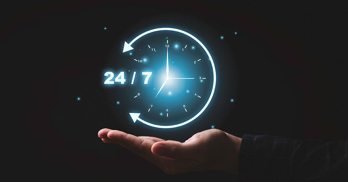 A hand holds a glowing clock icon with arrows encircling it and "24/7" written on the side, symbolizing continuous availability and seamless backup.