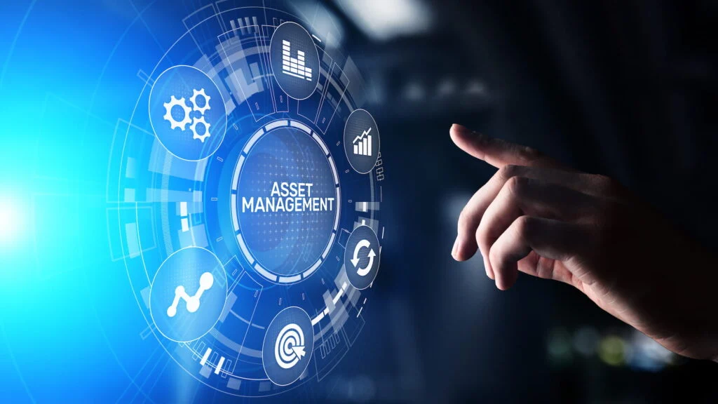 A finger reaches toward a digital interface displaying icons related to asset management, including graphs, gears, and a magnifying glass, all connected in a circular arrangement.